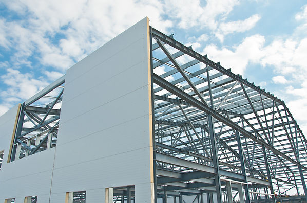 Metal frame of the building with a sandwich panel of insulation on the wall. Construction