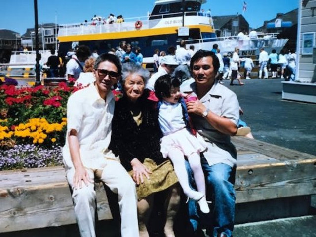 Me (on the far right, holding my daughter, Jan) with my mother and brother, 1989.