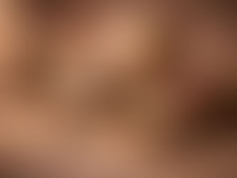 Still life with a stone engraved with a yin-yang symbol, a small globe, bowls of rice and fruit, a lit candle, incense, beads, old books, and a rolled scroll, arranged on a textured surface in warm, balanced light.