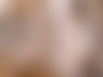 An elderly Sikh man wearing a white turban and traditional white robes sits cross-legged in quiet meditation beside the Guru Granth Sahib, which rests on a low stand draped in ornate golden cloth. His hands are open in a gentle posture of devotion, eyes lowered in contemplation. A chaur sahib lies across the scripture, with prayer beads and a small bowl placed nearby, while the Golden Temple and sacred pool appear softly out of focus behind carved stone columns, creating a serene, reverent atmosphere rooted in Sikh worship.