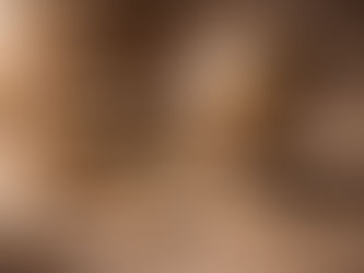 A contemplative still life on a stone surface featuring a vintage globe on a stand, an old book with a rolled parchment on top, a smooth stone, wooden prayer beads with a tassel, and a small sprig of dried leaves. The scene is softly lit and conveys reflection, humility, and a sense of the greater whole.