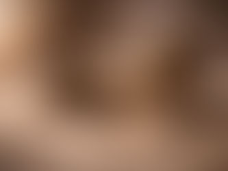 A contemplative still life on a stone surface featuring a small ornate incense burner releasing wisps of smoke, stacked smooth stones, a rolled parchment resting on an old book, dried herbs, and a few scattered stones. The scene is softly lit and evokes stillness, ritual, and quiet presence.