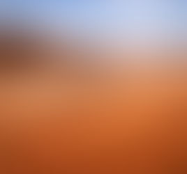 Sunlit desert landscape with rippled sand dunes, layered rock formations, and a vast open plateau beneath a clear blue sky, symbolizing divine reckoning and sufficiency.