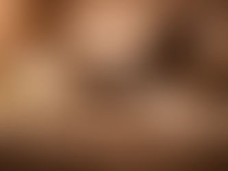 Still life with a sword resting across an old book, a white lily in the foreground, scattered coins and stones, a warrior’s helmet in the background, and an incense burner releasing smoke, arranged on draped fabric in warm, subdued light.