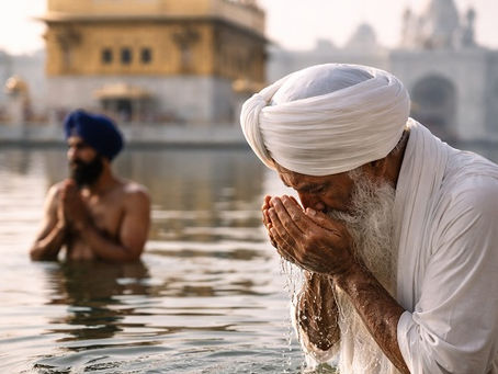An elderly Sikh man wearing a white turban and kurta stands waist-deep in the sacred pool of the Golden Temple, gently cupping water in his hands and bringing it to his face in a quiet act of devotion. Behind him, another Sikh man in white stands in the water with hands folded in prayer, facing the temple. Soft morning light reflects off the calm water and the golden sanctum, creating a serene, reverent atmosphere rooted in Sikh spiritual practice.