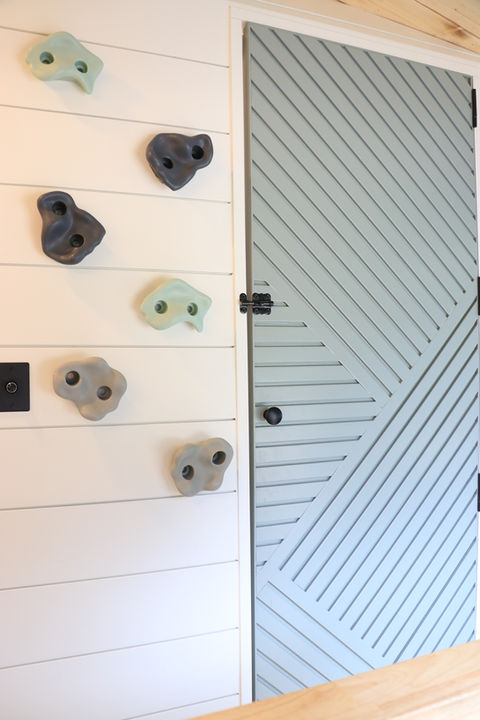 Close-up of custom-built shower door in Sarah’s Ford Transit Nomadik campervan, featuring minimalist framing and modern design by Drifter Vans