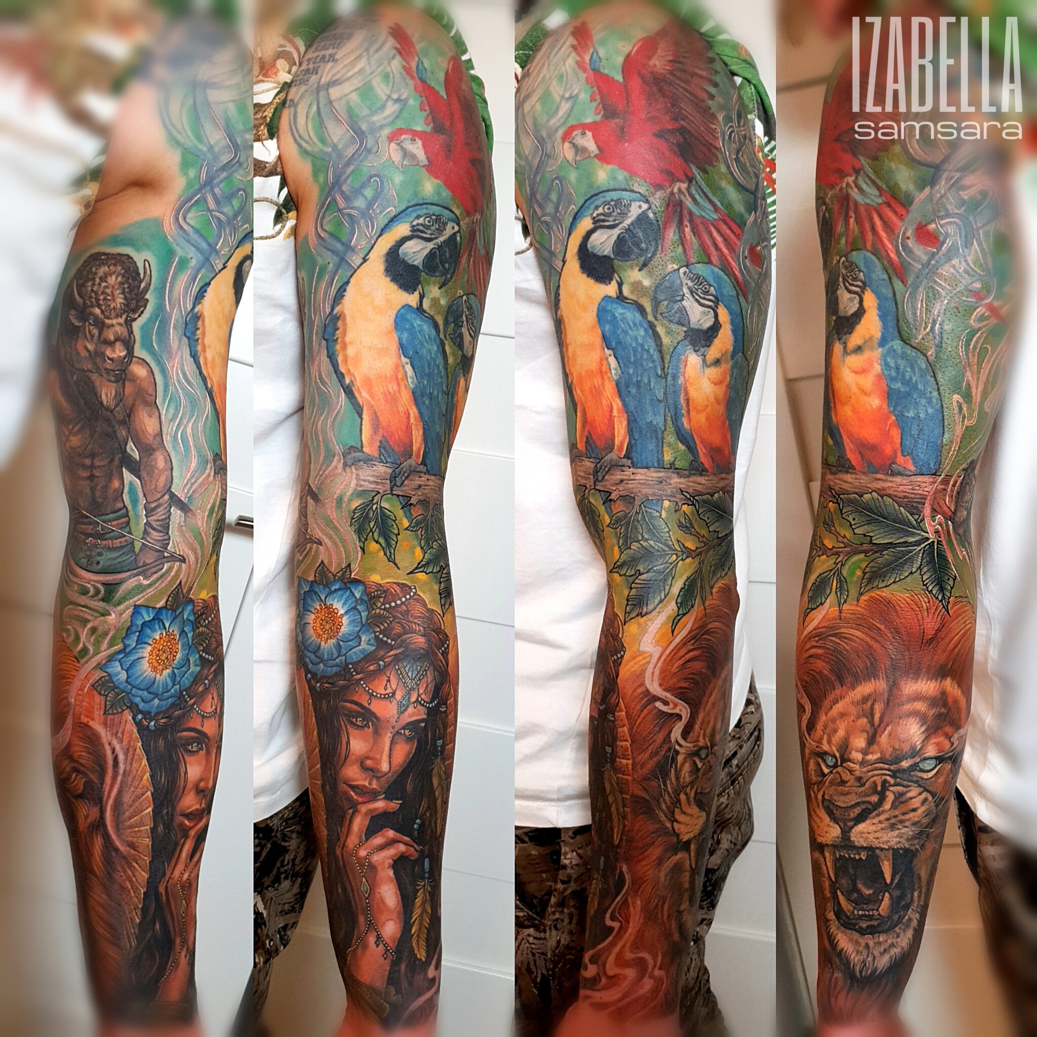 Vibrant tattoo sleeve featuring a colorful design with two macaws perched on a branch, a powerful lion's face, a woman with flowing hair adorned with jewelry and floral elements, and a mythical warrior figure, all surrounded by lush foliage and vivid background colors.
