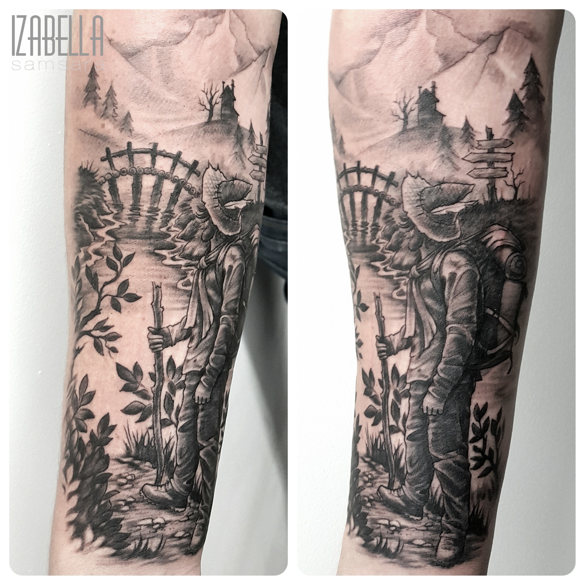 A detailed black and grey tattoo depicting a hiker standing by a serene lake surrounded by mountains. The hiker is wearing a hat, carrying a backpack, and holding a walking stick. In the background, there is a wooden bridge and signposts, along with lush greenery and trees, creating a tranquil nature scene.