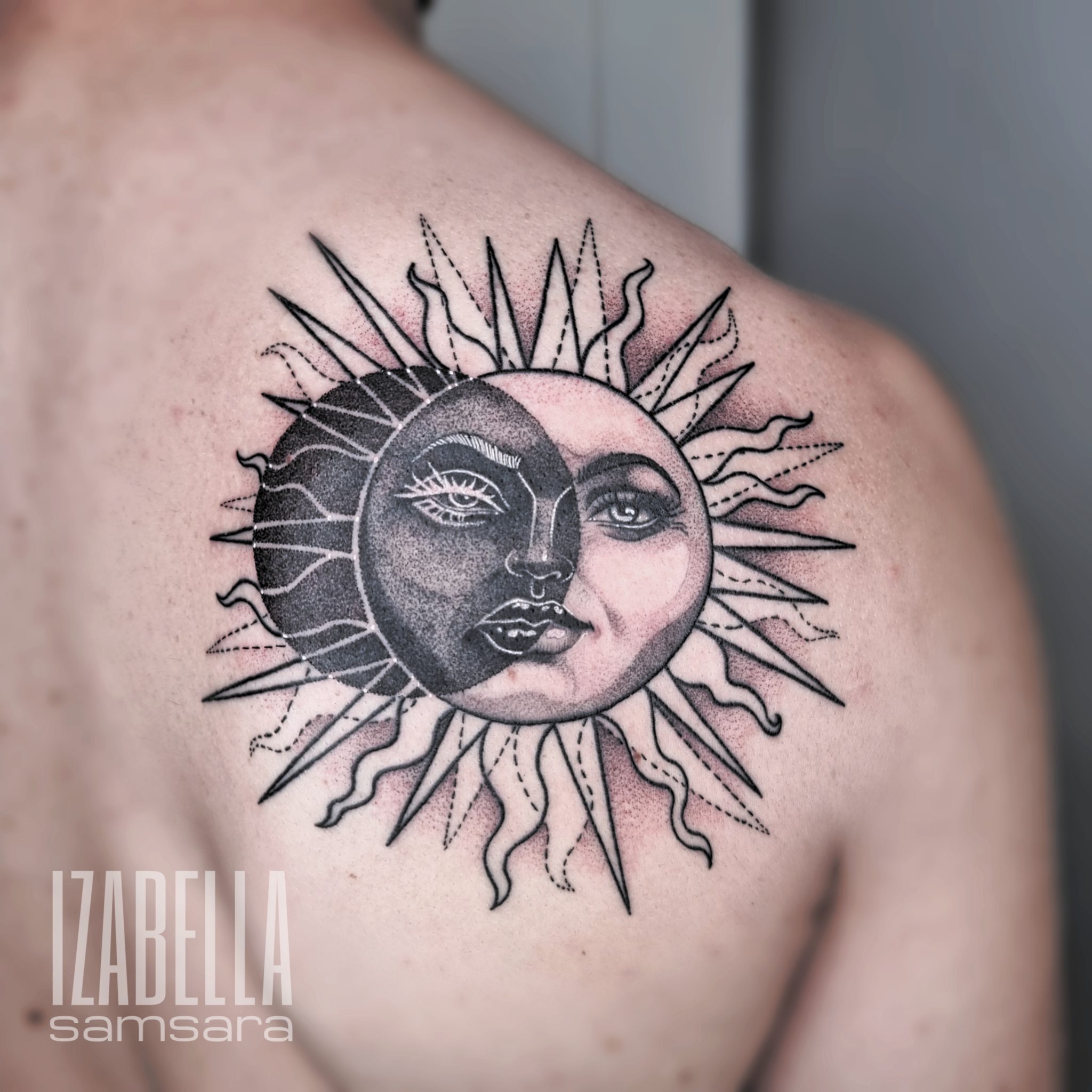 A beautifully detailed tattoo of a sun and moon design on the shoulder, featuring a stylized sun with rays and a half-moon face. The sun is outlined with sharp, extending sun rays, while the moon has intricate facial features, contrasting black and white elements, showcasing elegance and harmony between day and night.