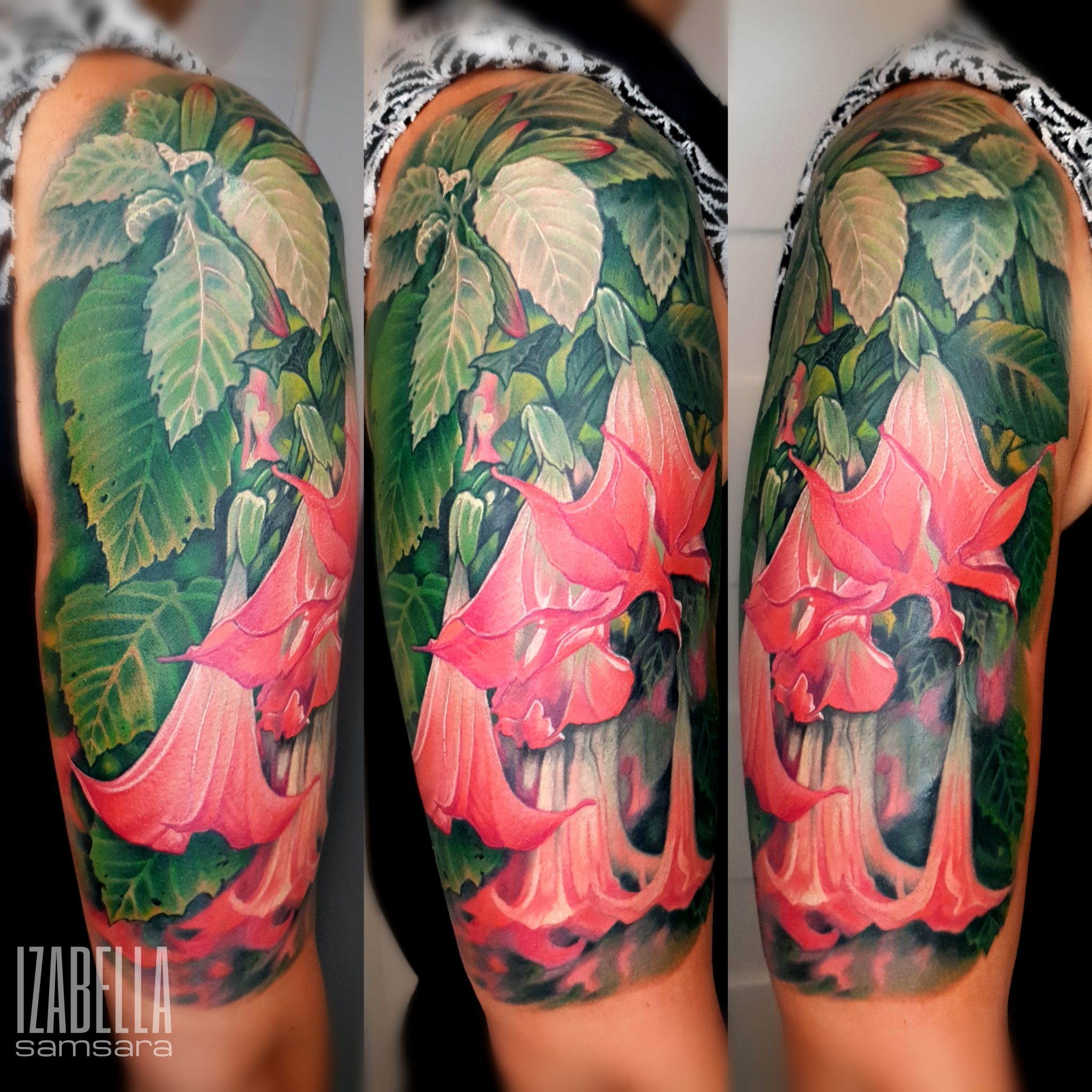 A vibrant tattoo featuring pink trumpet flowers surrounded by lush green leaves, covering the upper arm. The design showcases intricate details and a realistic style, with a blend of bright colors and shading that creates depth, making it an eye-catching floral piece.