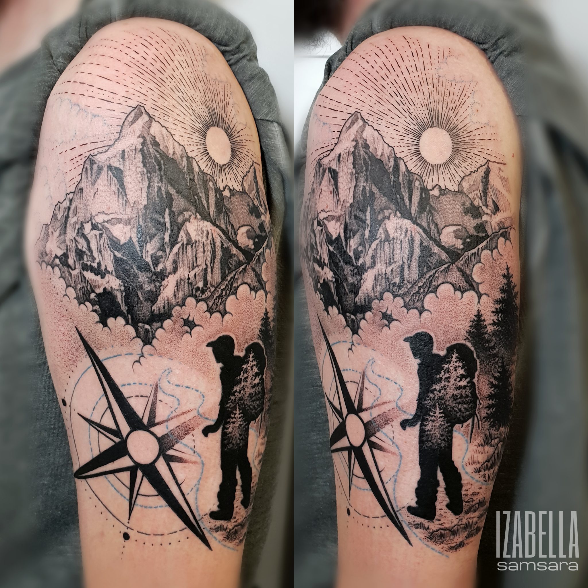 A detailed black and grey tattoo featuring a mountainous landscape with clouds and a sun at the top. In the foreground, there is a silhouette of a hiker with a backpack standing beside a compass rose, which includes sharp points and circular designs.