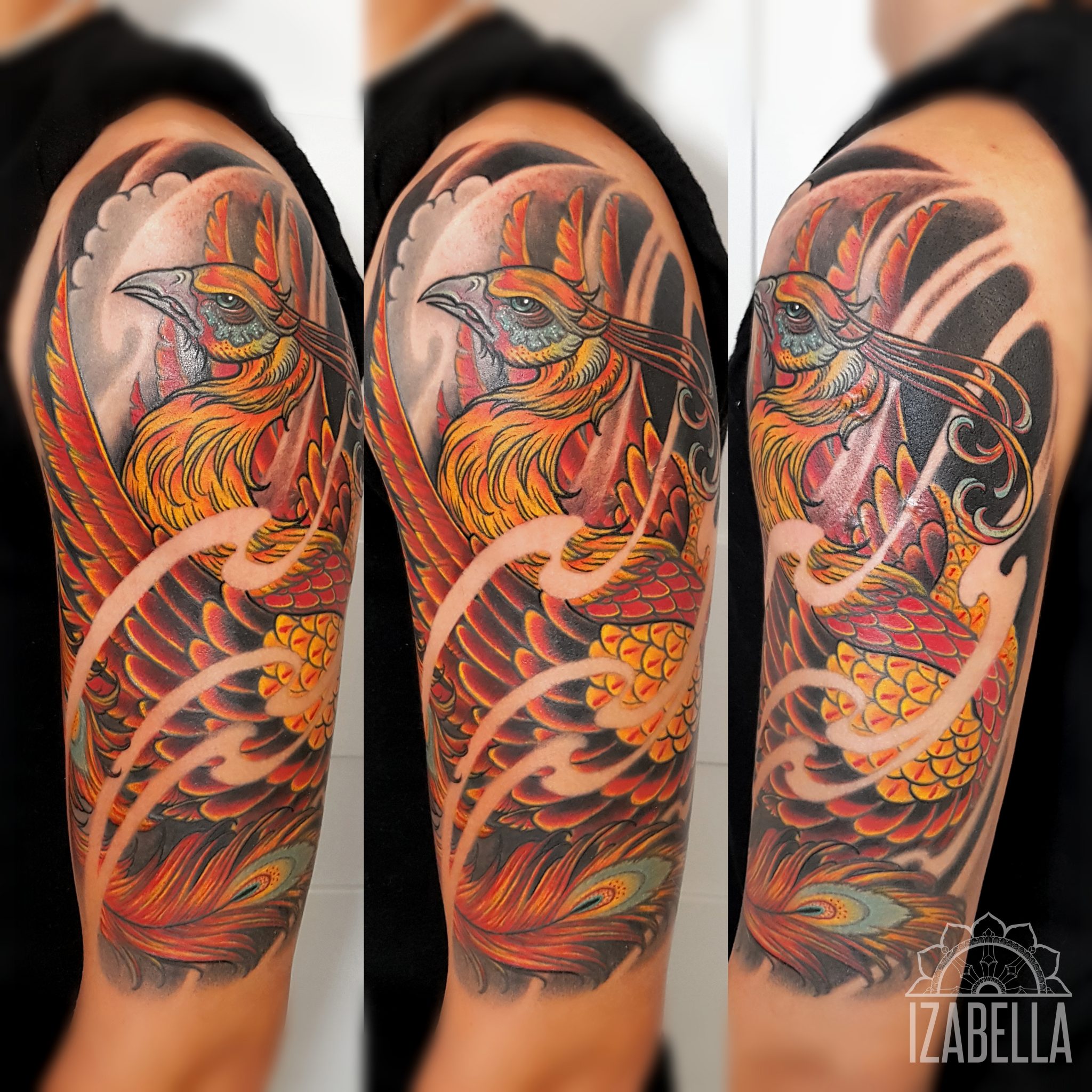 A vibrant tattoo design featuring a majestic phoenix with an array of fiery colors, including reds, oranges, and yellows. The bird is intricately detailed, showcasing its feathers and fierce expression, surrounded by swirling patterns and dark shades that enhance its vividness. The tattoo is displayed on a person’s upper arm, emphasizing its dynamic composition and artistic flair.