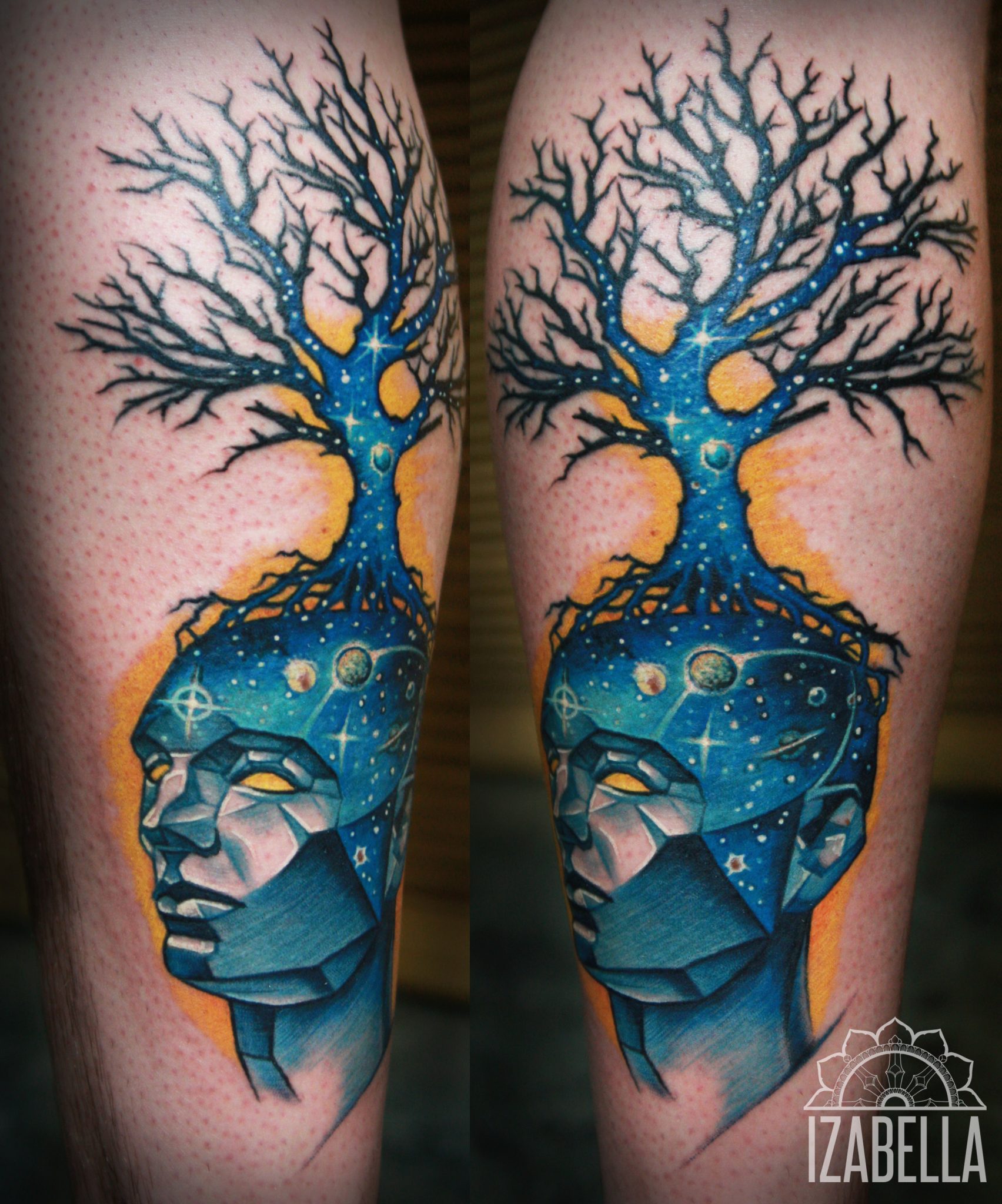 A vibrant tattoo featuring a stylized human head with a vibrant blue and orange color scheme. The top of the head merges into a tree silhouette, with intricate branches extending upwards. The head is designed with geometric shapes, and the background includes celestial elements like stars and planets, symbolizing a connection between nature and the cosmos.
