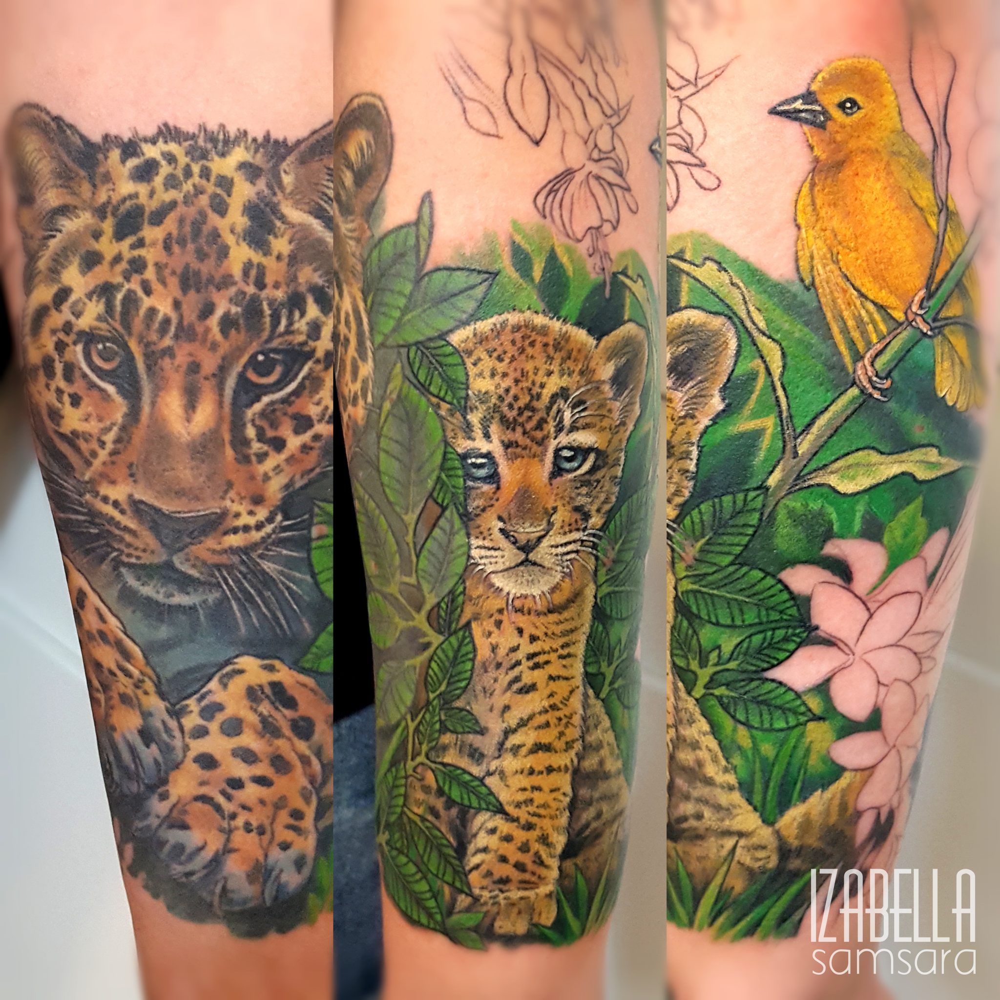 A vibrant tattoo featuring a realistic depiction of a leopard and a young lion cub, surrounded by lush green leaves and pink flowers. A bright yellow bird perches on a branch, adding a splash of color to the nature scene. The artwork showcases intricate details and lifelike expressions, highlighting the beauty and majesty of these animals.