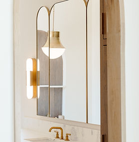 Custom arched tri-panel gold mirror with beveled edges, installed above marble bathroom vanity, Oklahoma City 