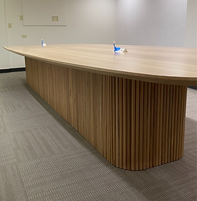 Custom white oak conference table with reeded pedestal base, built for commercial office in Oklahoma City 