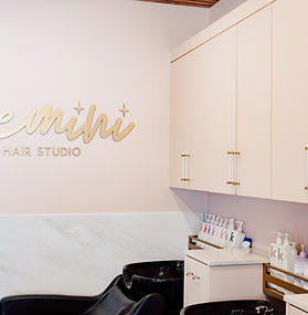 Custom commercial salon cabinetry with brass hardware and gold accent shelving, Oklahoma City 