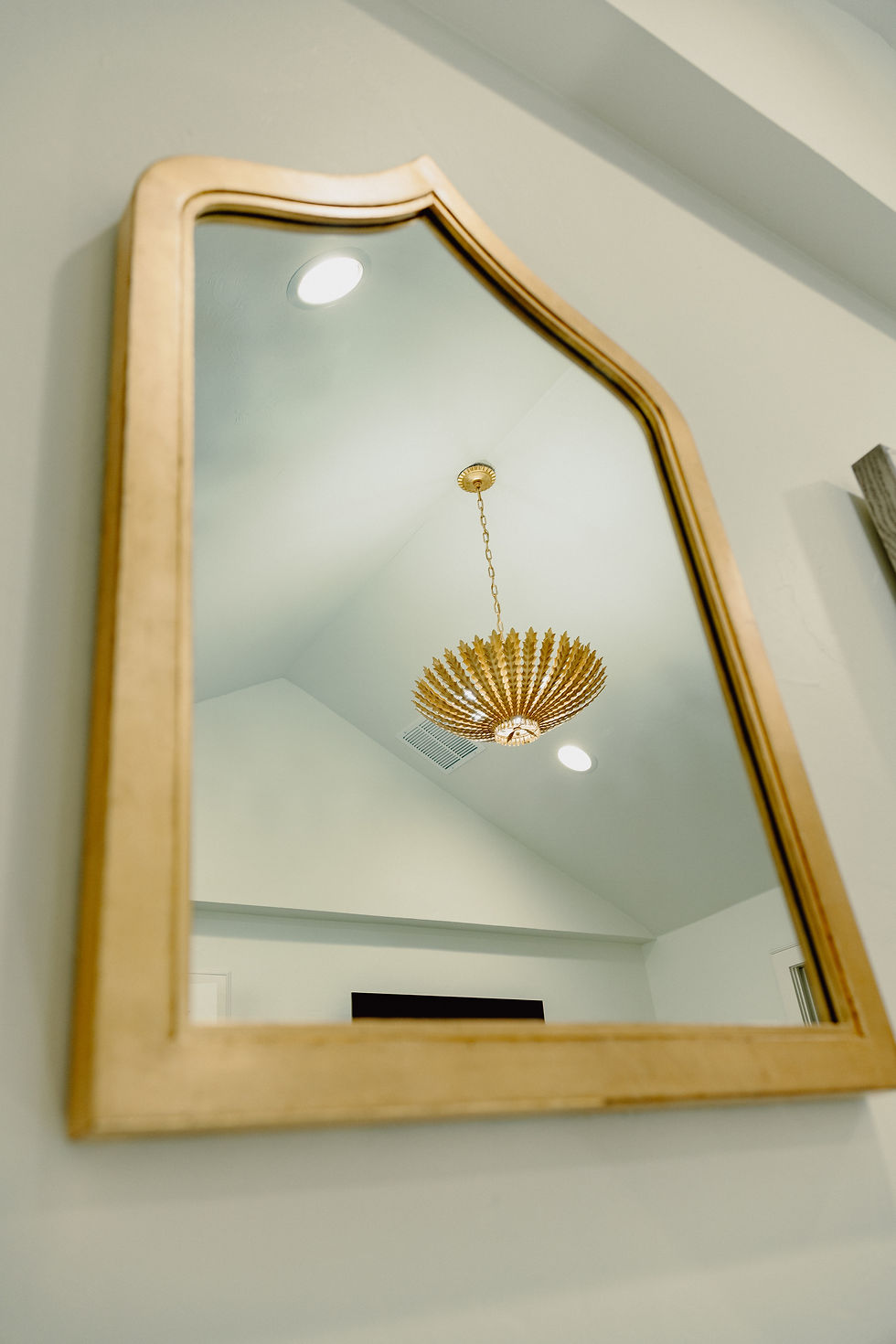 Custom metal framed wall mirror with shaped silhouette and gold leaf finish, handcrafted in Oklahoma City