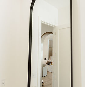 Custom black steel arched full-length floor mirror for modern bathroom, handcrafted in Oklahoma City 