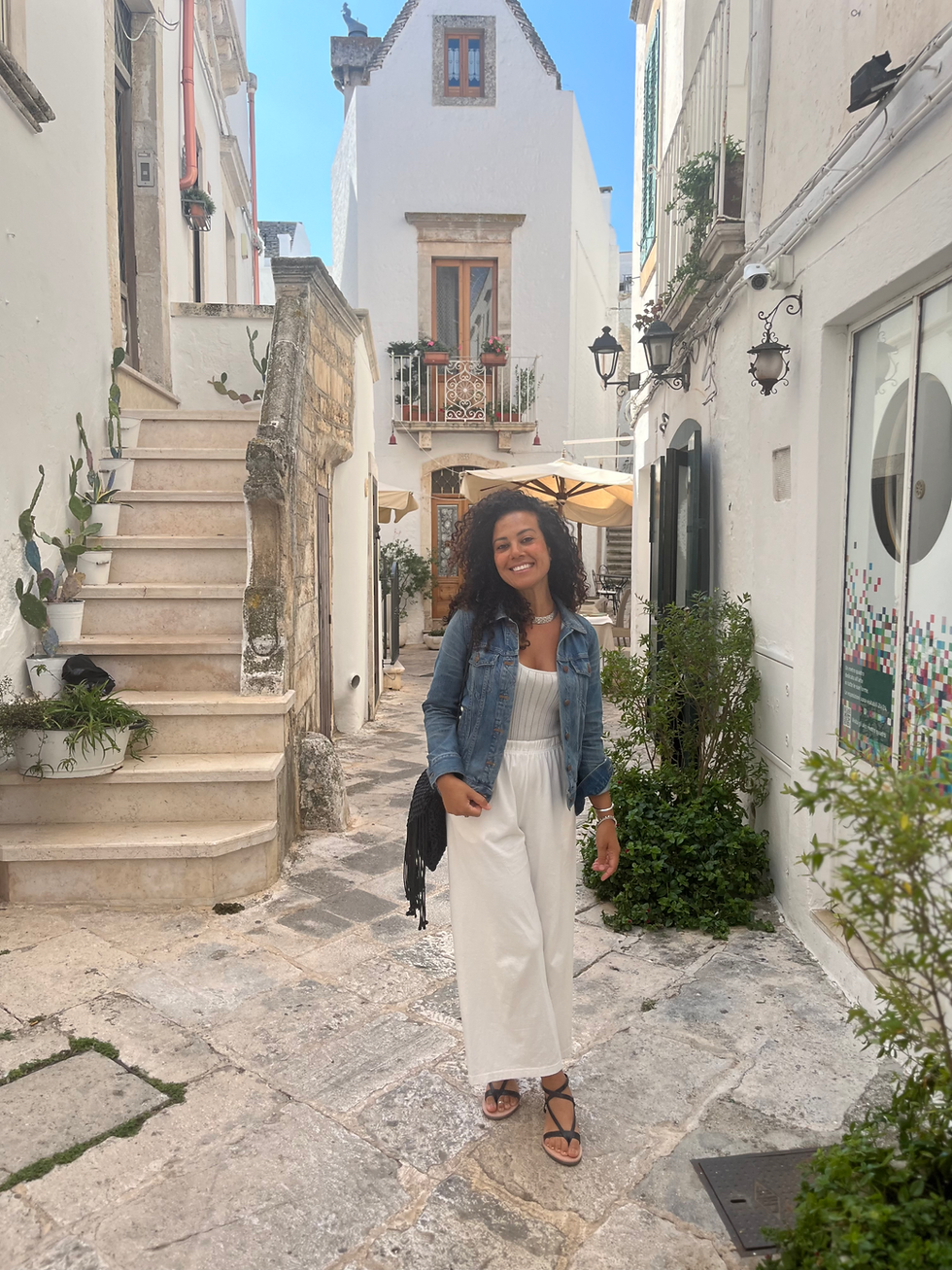 Mara smiling in the Italian countryside, bringing her warmth and holistic healing expertise to Serenità Retreats, a women's wellness retreat