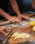 Hands making fresh pasta during a pasta cooking class at an Italian women’s wellness retreat in Italy