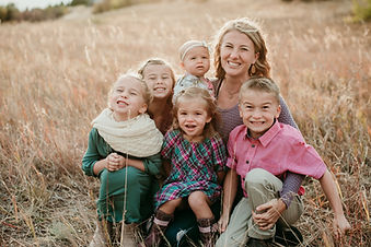 Cute family posing for the camera in field