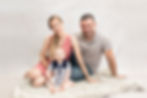 Family sitting on a throw