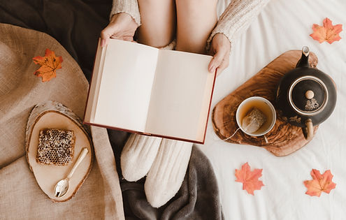 crop-woman-with-book-near-tea-honeycomb.jpg