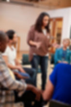woman-standing-to-address-self-help-therapy-group-2026-01-05-22-47-53-utc.jpg