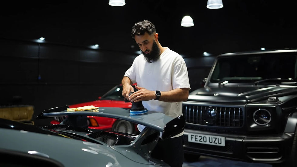 A MAN DOING WORK ON A CAR