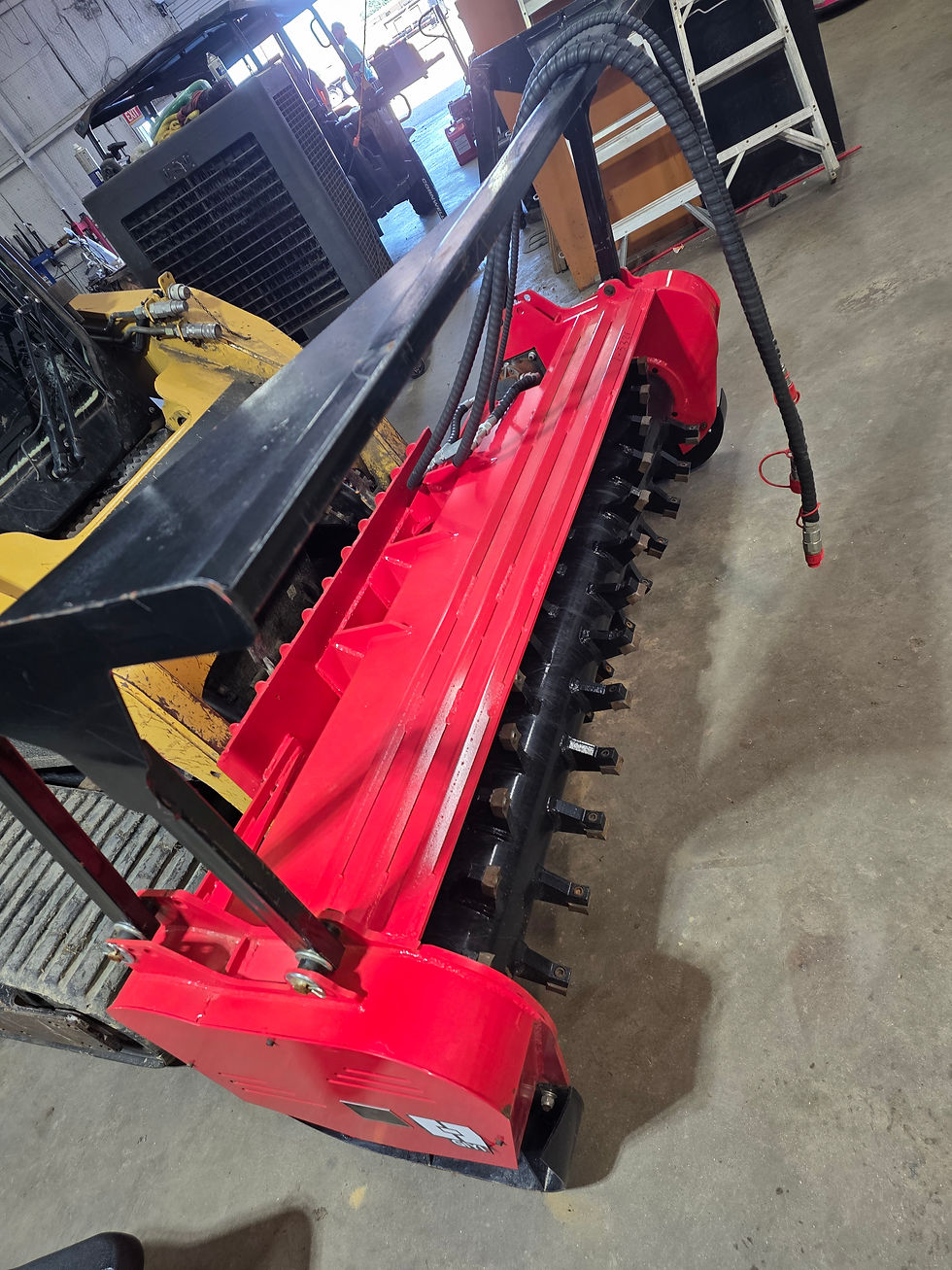 Side view of GIYI Skid Steer Mulcher (red)
