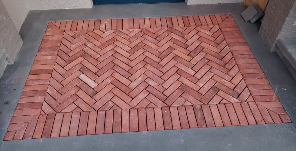 Completed installation of herringbone patterned red bricks