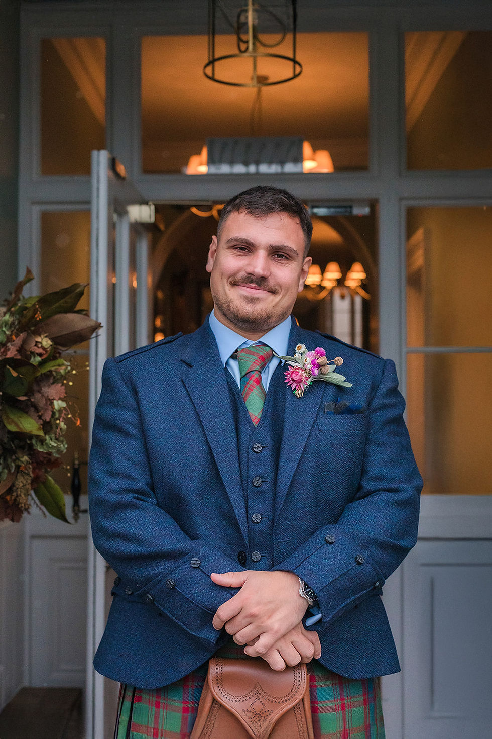 katy brothers POST groom smiling by front door portrait