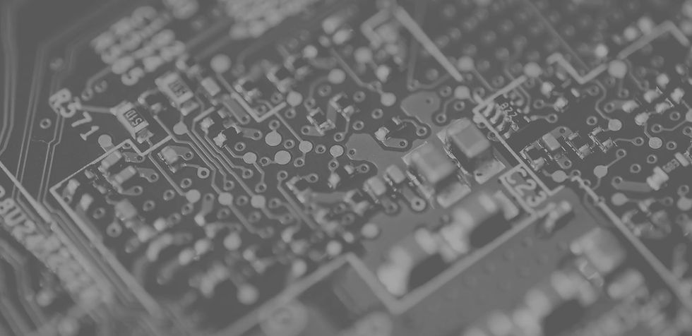 Close-up of a dark circuit board with microchips.