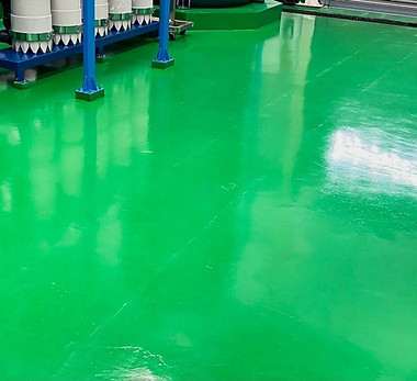 stock-photo-the-concrete-floor-is-covered-with-green-epoxy-in-the-factory-where-the-steel-