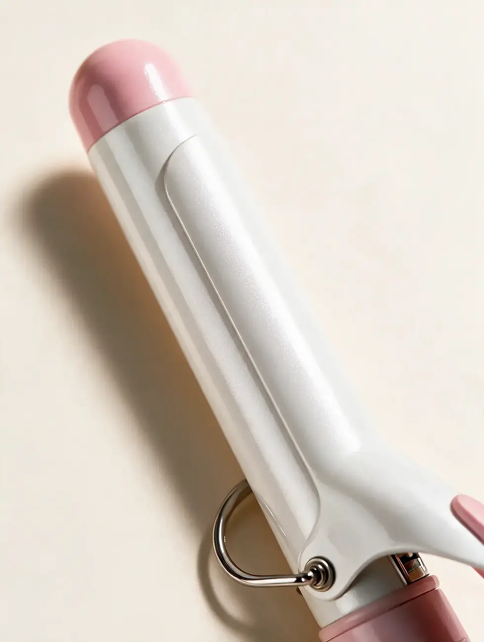 Close-up of a 1.25 inch curling iron barrel with pearl white ceramic finish and pink tip