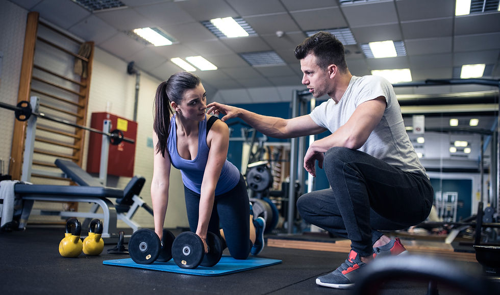 A personal trainer working with a client to improve her movement and fitness.