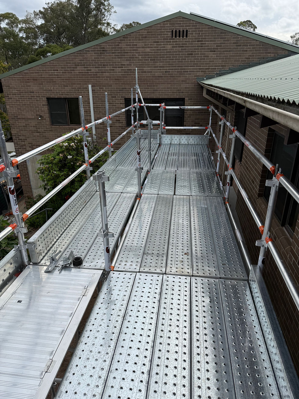 QuickStage aluminium scaffold platform with full handrails, midrails, and toe boards installed to Australian safety standards.