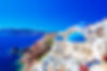 Oia town on Santorini island, Greece. Traditional and famous houses and churches with blue