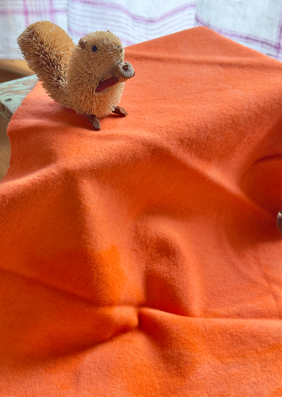 orange hand dyed wool with a brush squirrel on top