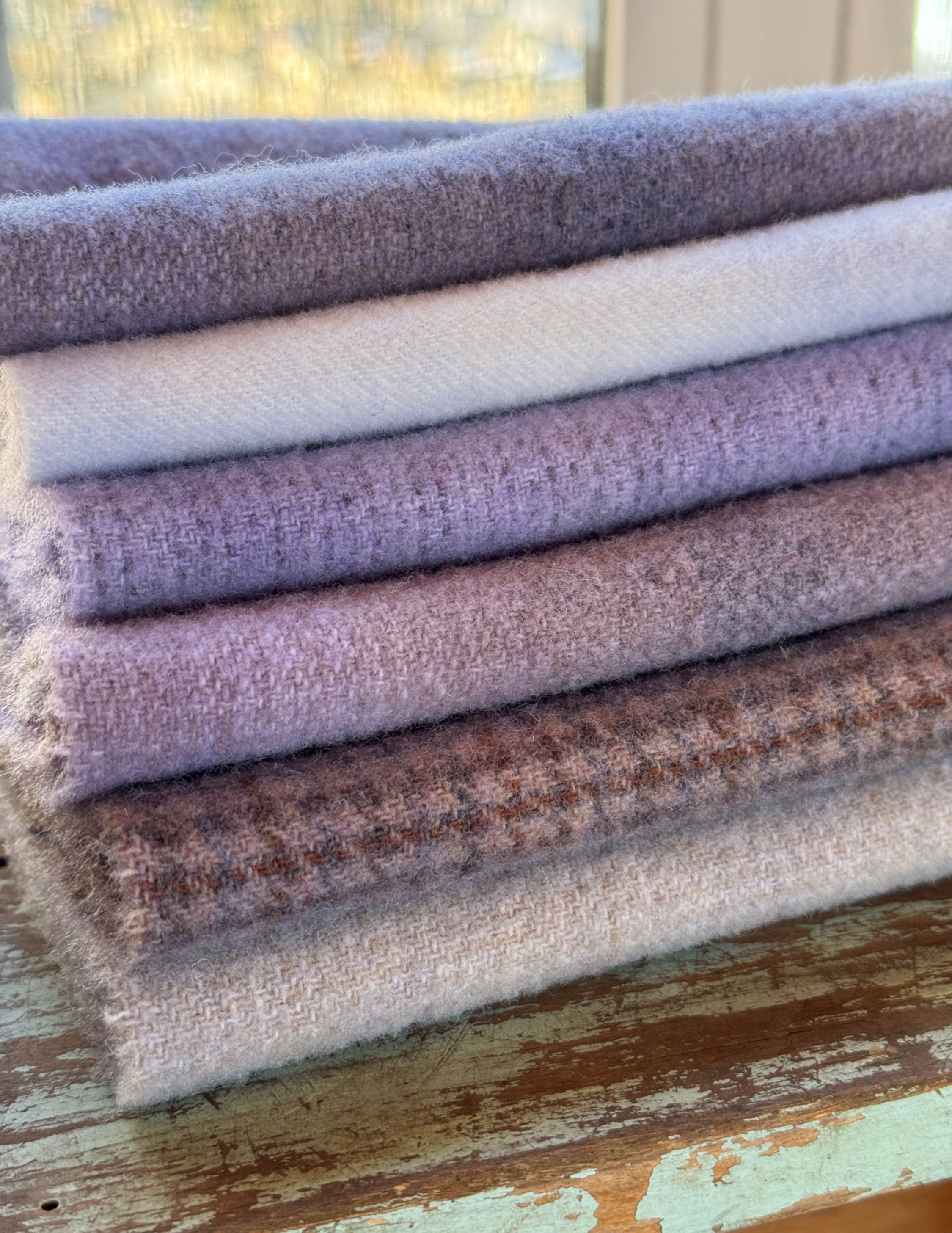 stack of folded hand dyed wool fabric fat sixteenths in Periwinkle