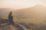 woman-sitting-floor-looking-sunset.jpg