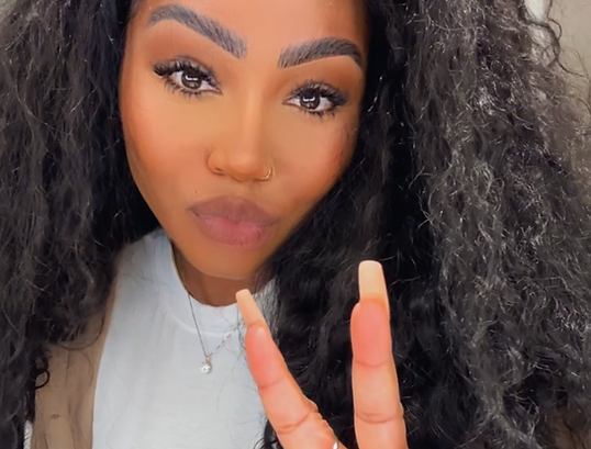 black girl with curly raw indian hair extensions