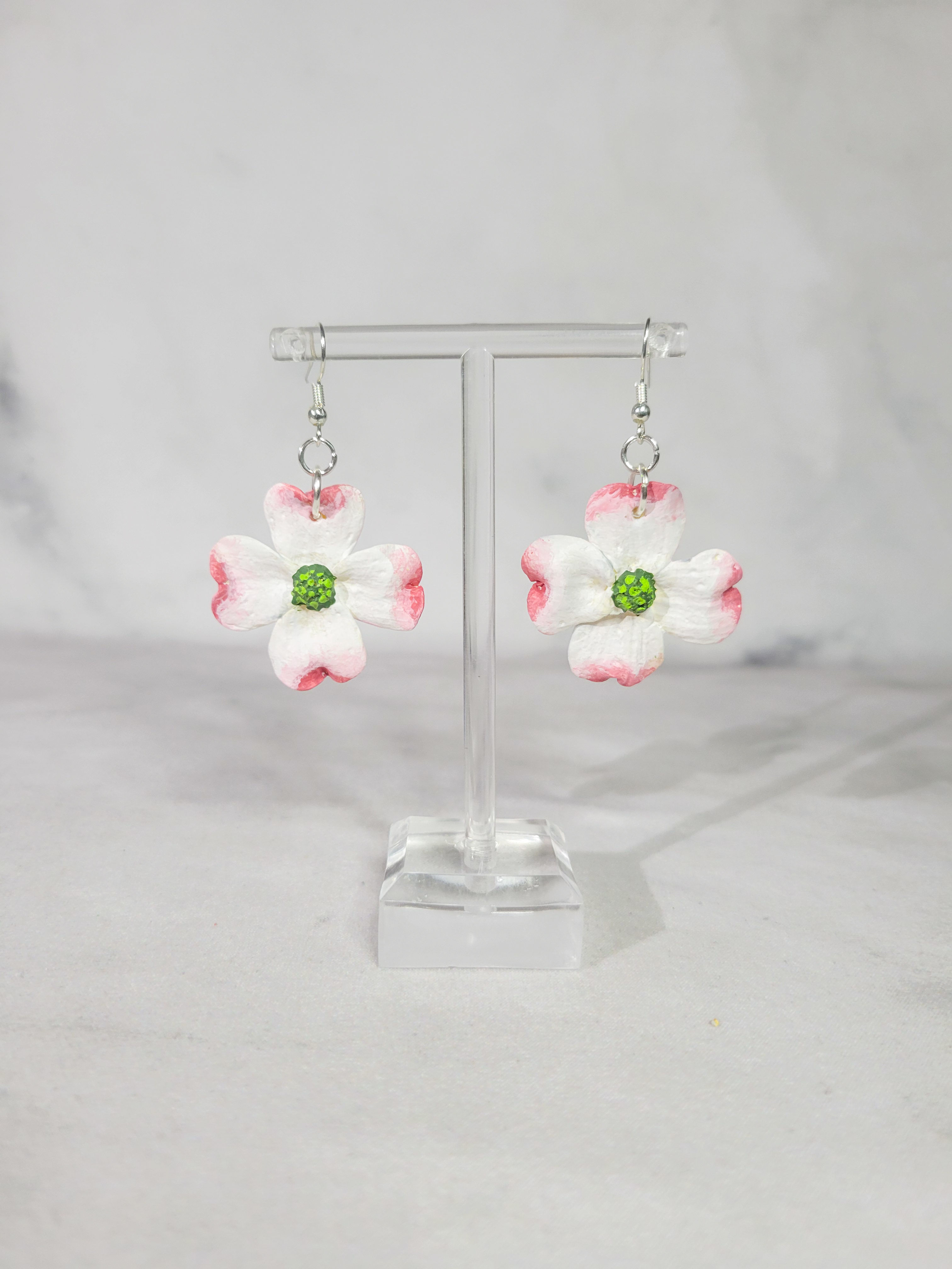 White and pink flower earrings on display