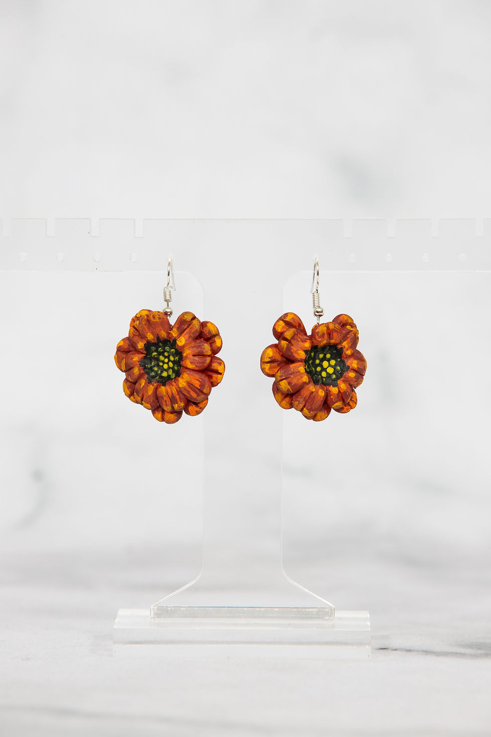 Orange flower earrings with yellow and black centers