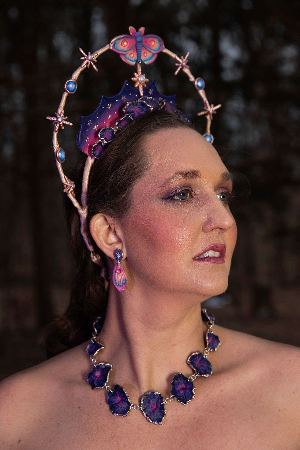 Thumbnail: Woman wearing celestial-themed jewelry, gazing into distance