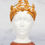 Thumbnail: Gold laurel crown on a white mannequin head, displayed on wooden stand.