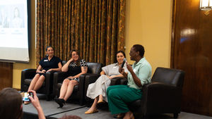 Four women talking in a panel presentation