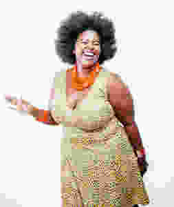 Happy woman wearing a printed dress and bright orange accessories