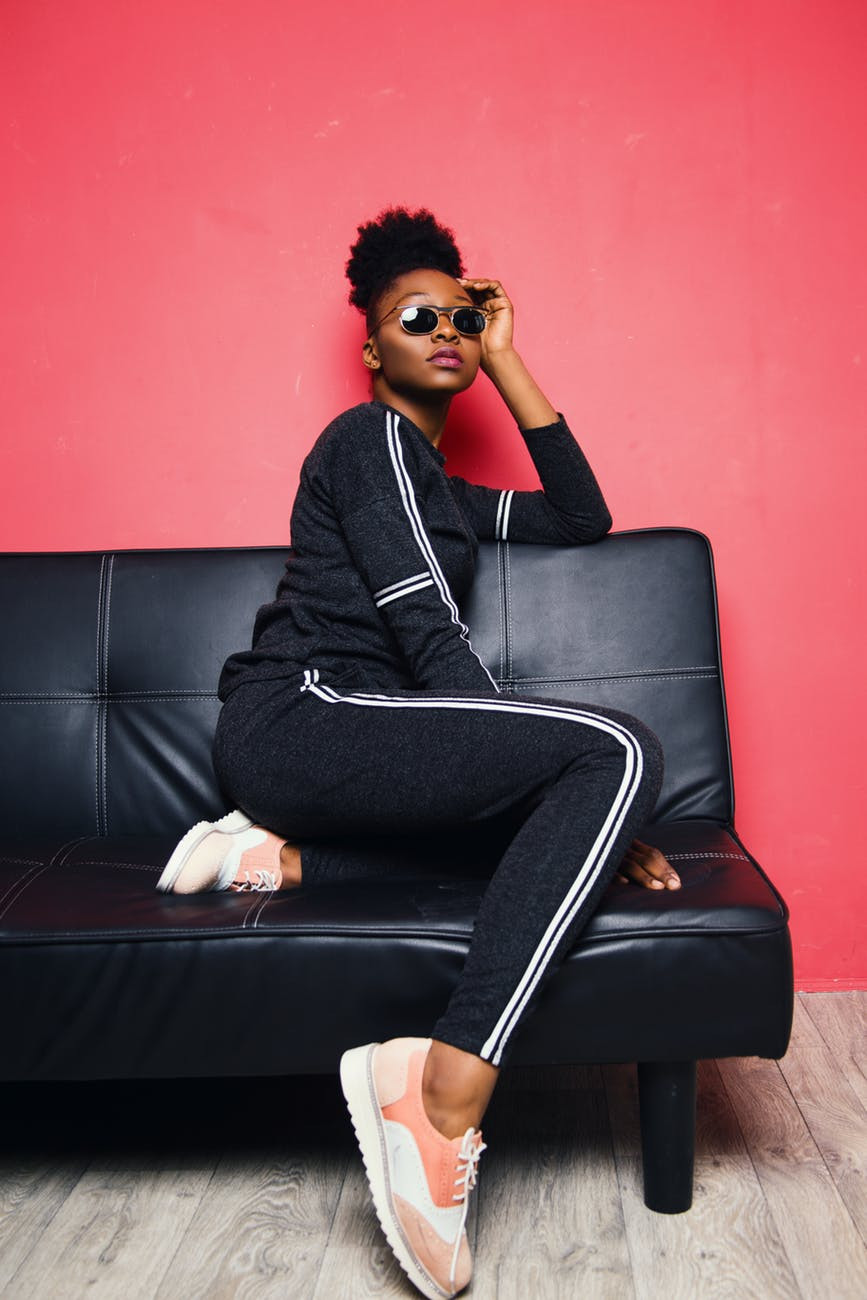 Woman sitting down in a chair wearing a track pants suit